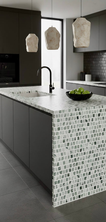 Modern kitchen featuring Carlo Scarpa - Green Vibes tiles by New York Cement Tile, matte gray cabinets, and pendant lighting.