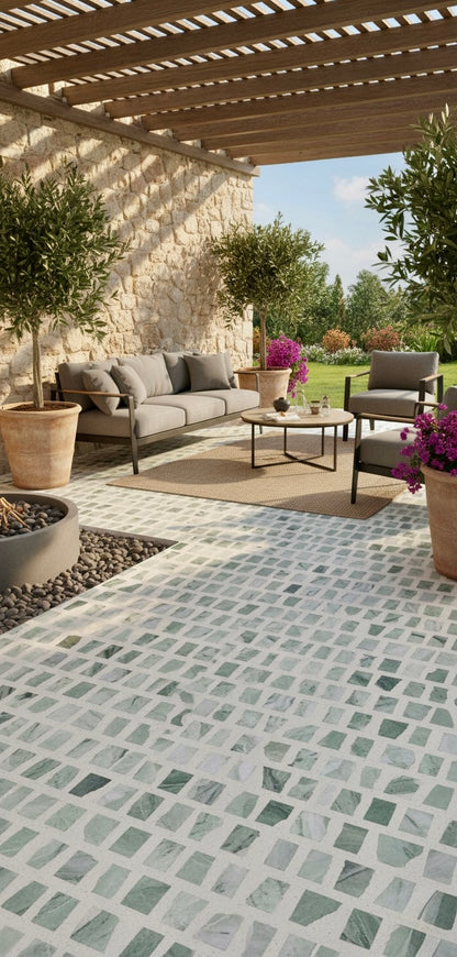 The Carlo Scarpa - Green Vibes tiles by New York Cement Tile enhance this patio with stone walls and a gray sofa set.