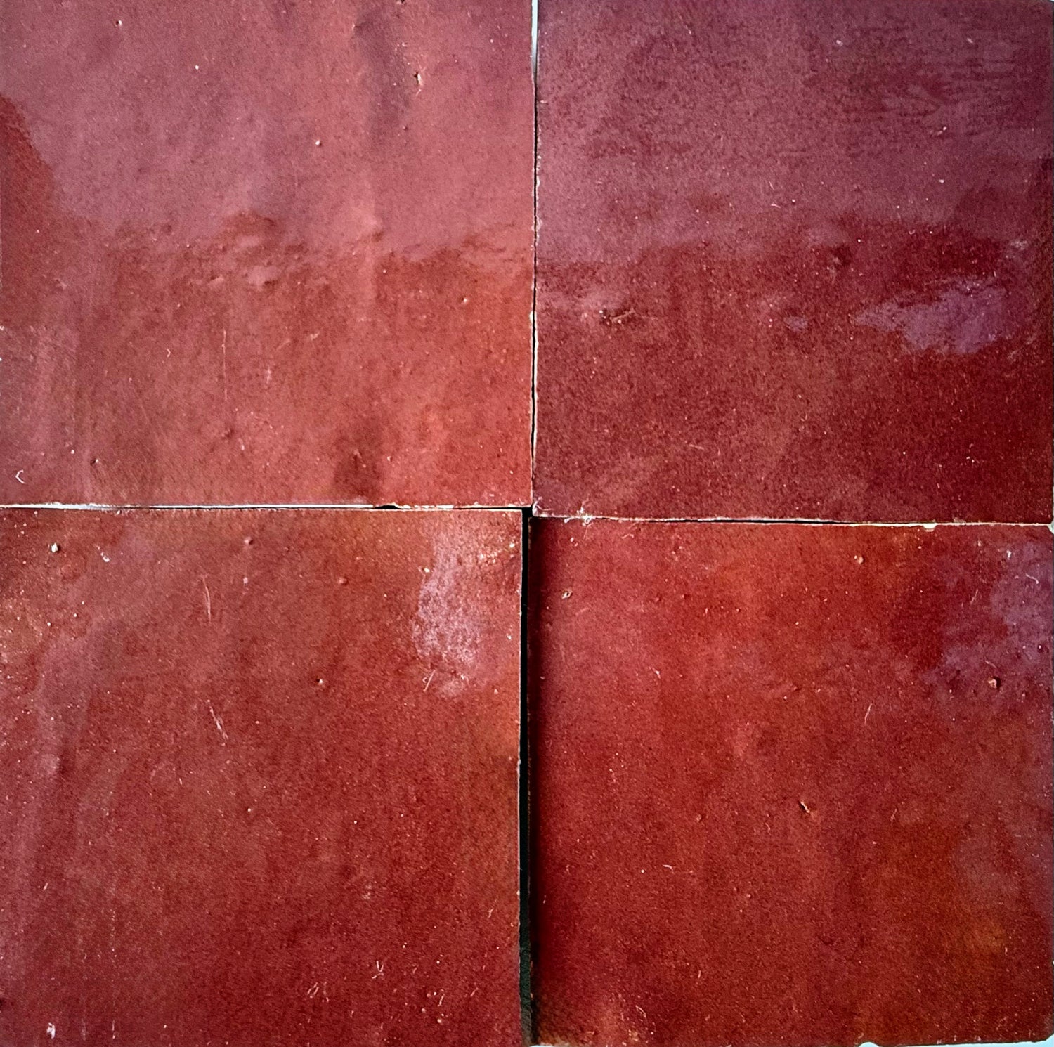Four square Chocolate Cherry tiles by New York Cement Tile, arranged in a grid with visible seams between each handcrafted tile.