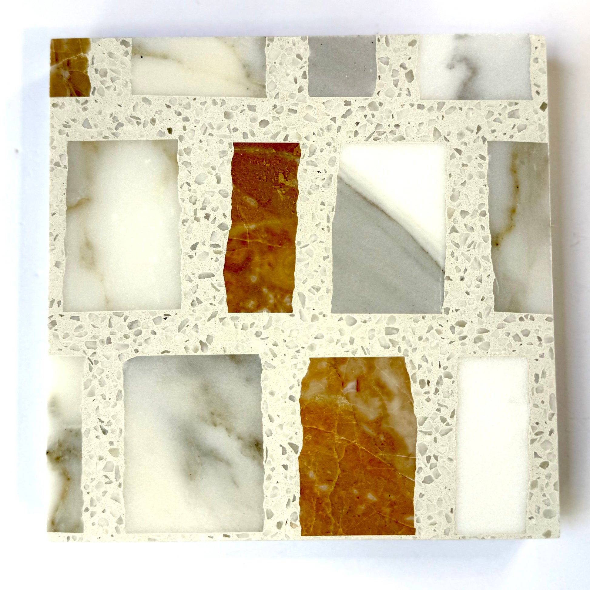 Carlo Scarpa - Mountain High by New York Cement Tile features a grid of white, gray, and brown marble on a terrazzo-look background.