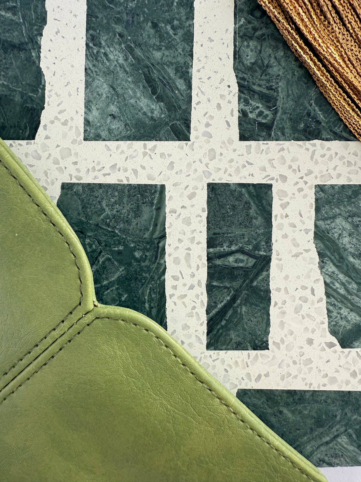 Carlo Scarpa - Emerald Green by New York Cement Tile: green leather, terrazzo with marble squares, and gold fringe in a geometric pattern.