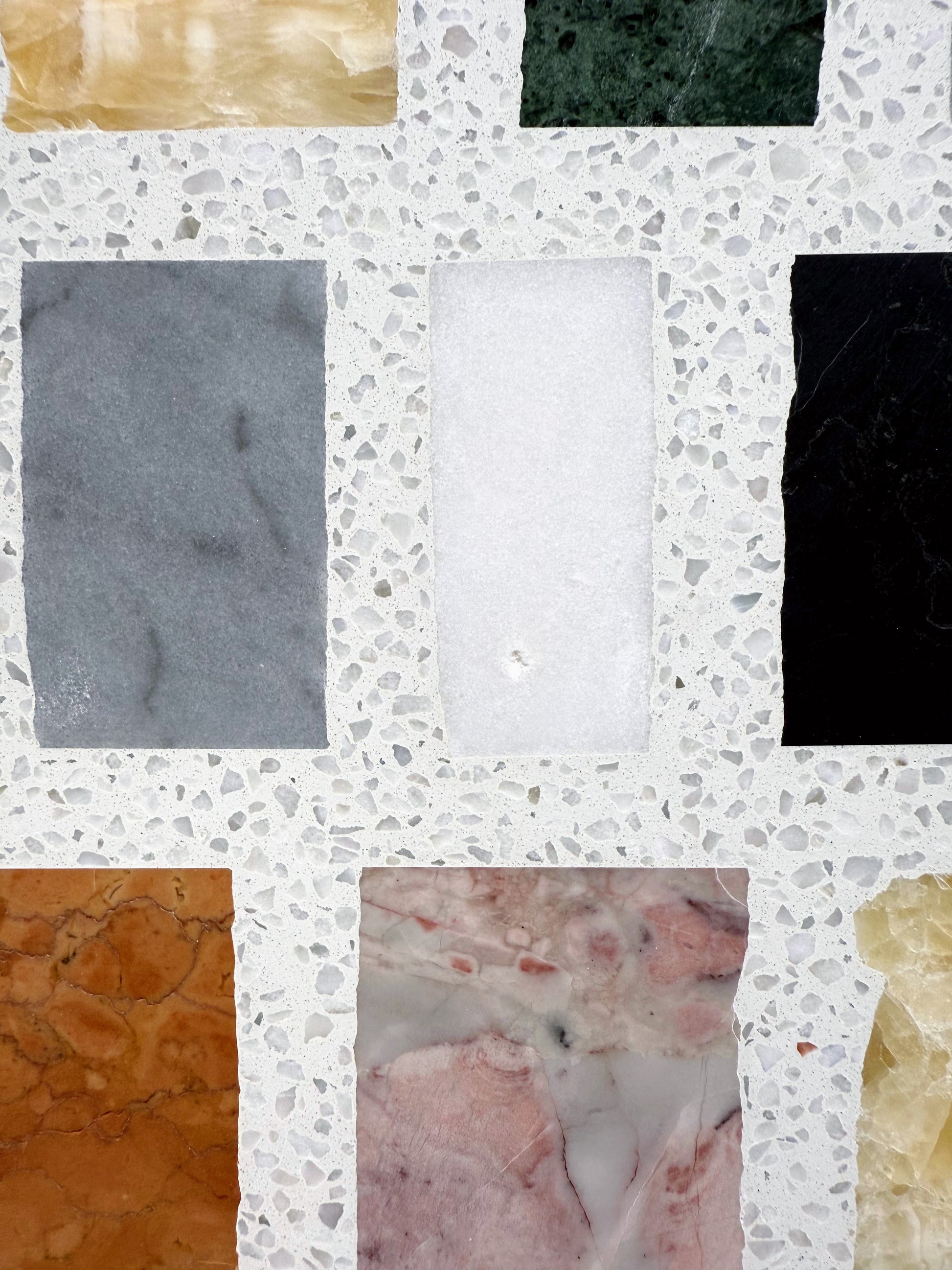 Carlo Scarpa-Multicolor by New York Cement Tile: multicolor rectangular tiles in a terrazzo-style white concrete background.