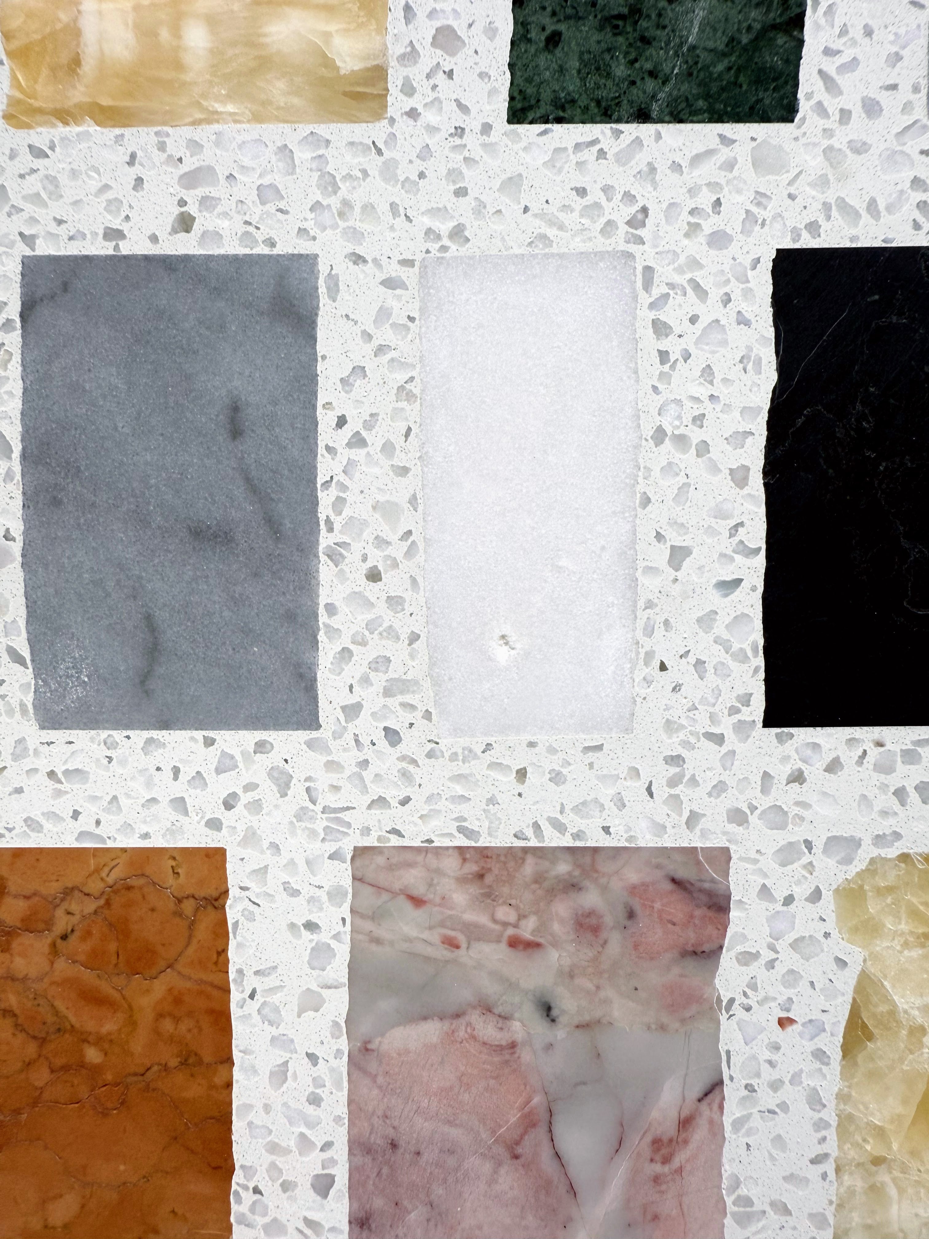 Carlo Scarpa-Multicolor by New York Cement Tile: multicolor rectangular tiles in a terrazzo-style white concrete background.