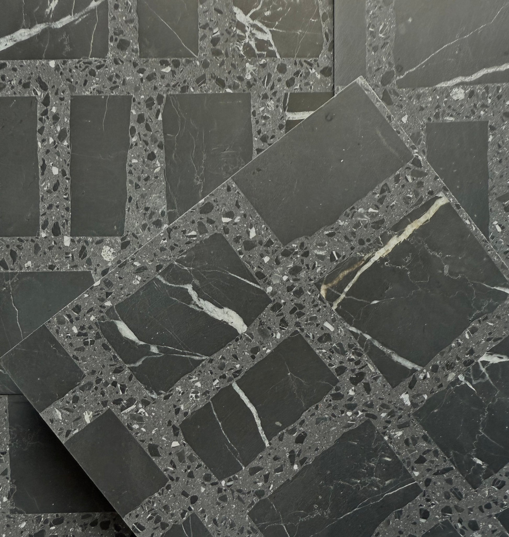 Carlo Scarpa-Black by New York Cement Tile: black tiles with rectangular shapes and speckled geometric patterns.