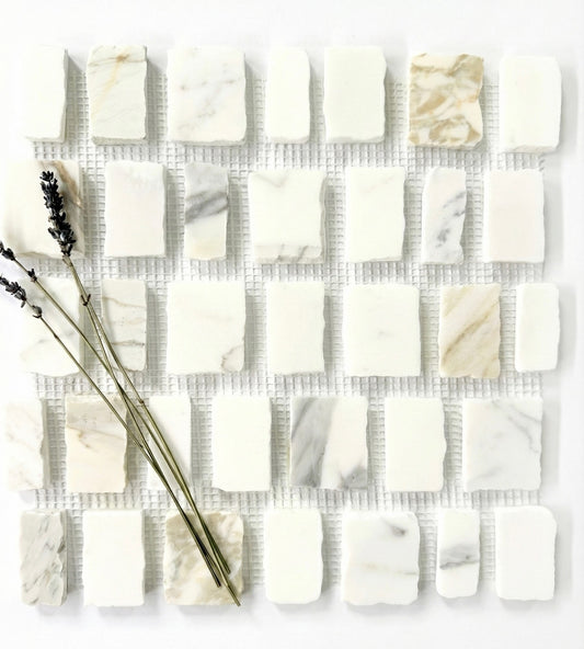 Scarpa I Calacatta Gold Marble Mesh by New York Cement Tile, accented with dried lavender sprigs.