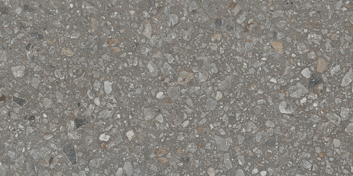 Close-up of Java - Perenne by New York Cement Tile, featuring rough gray concrete with small stones for urban elegance.