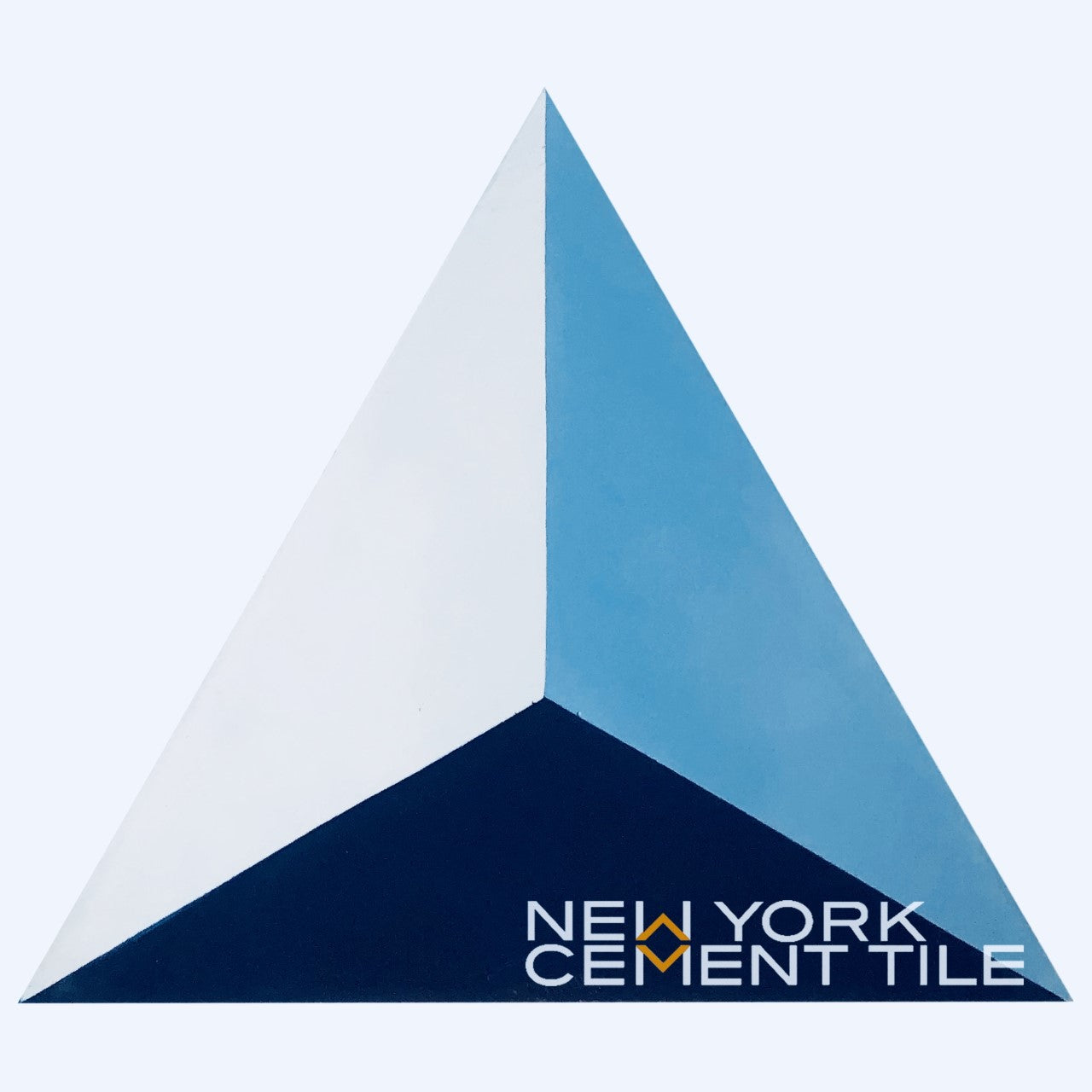 Blue and white geometric triangle from the Geometrika collection, NLT-9 by New York Cement Tile in bottom right corner.