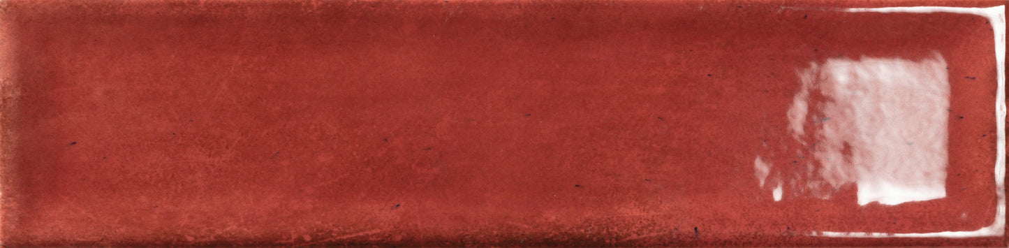 Ruby - Raku - Sample by New York Cement Tile: a glossy red rectangular ceramic tile with a white reflective patch.