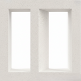 The Lucia by New York Cement Tile is a white concrete privacy screen with two deep vertical rectangular cutouts.