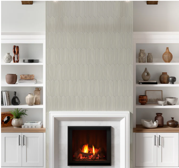 Modern fireplace with CRAFT II- PICKET CERAMIC- Fawn tile by New York Cement Tile, flanked by white shelves and decor.