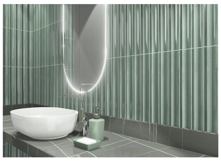 Modern bathroom with TUBAGE-ALOE tiles by New York Cement Tile, sculptural mirror, and white sink on dark countertop.