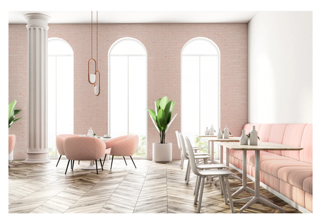 A modern cafe with pink chairs, white tables, and New York Cement Tile's CORRAZZO-ROSA ceramic tile accents.