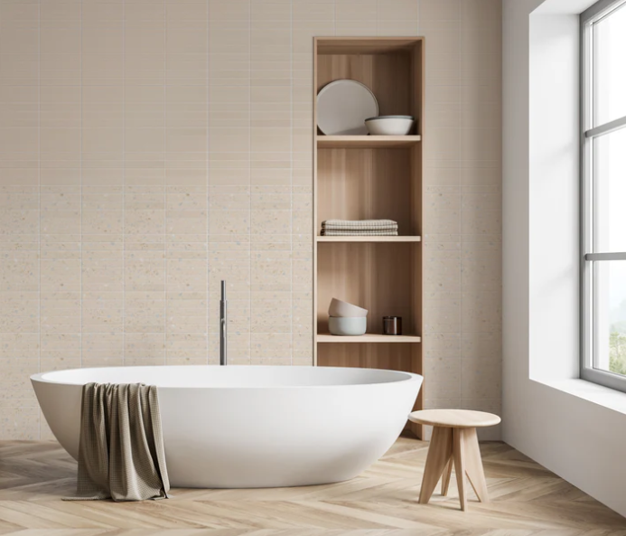 Modern bathroom with a white oval tub and wood accents, featuring New York Cement Tile’s CORRAZZO-HUESO ceramic tile.