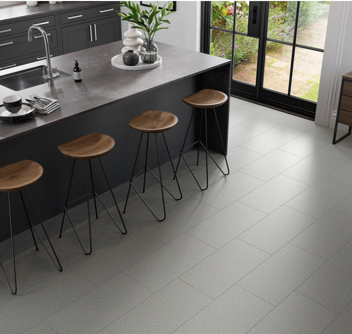 Modern kitchen with a black island, gray cabinets, and FRAGMENTO-WHITE SMALL SPECKLE by New York Cement Tile countertop.