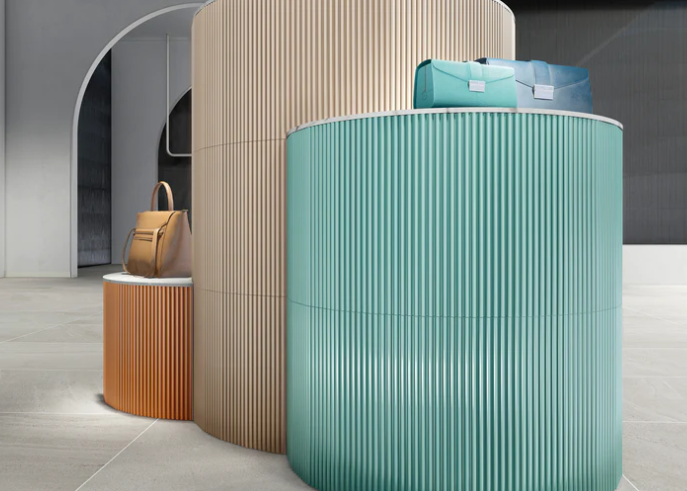 Three stands hold handbags and a duffel bag by arched walls with New York Cement Tile's PICCOLO-OCEAN, Sample.
