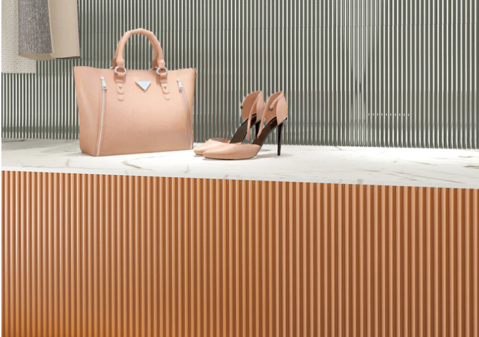 A beige handbag and high heels on marble, set against New York Cement Tile's PICCOLO-PAPAYA sample for retro elegance.