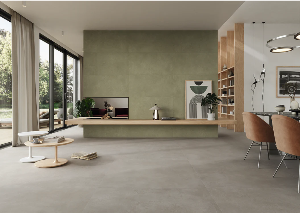 Modern living room with open shelves, green wall, and AGIO 24"x47" SLIM-Menta tile by New York Cement Tile in the dining area.
