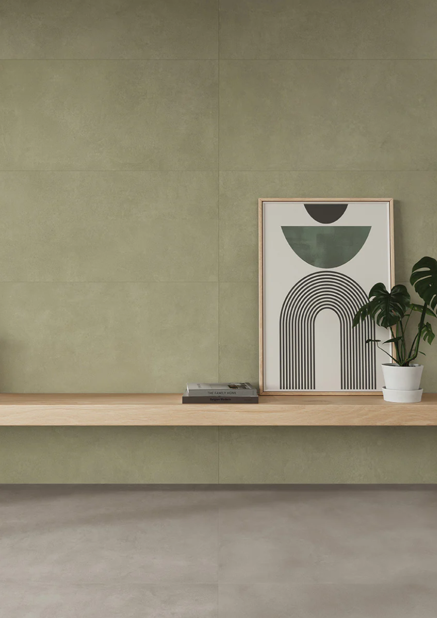 Modern minimalist interior featuring AGIO 24" x 47" SLIM-Menta tiles by New York Cement Tile, books, art & green wall.