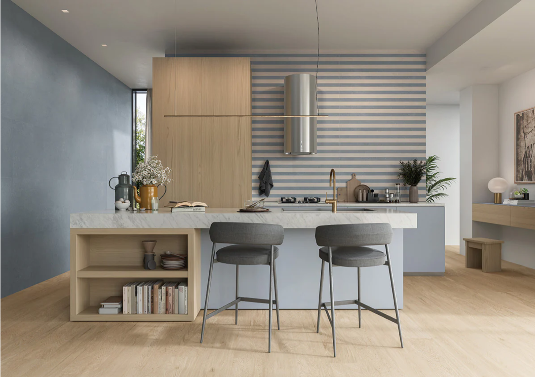 Modern kitchen with blue AGIO tile from New York Cement Tile, light wood cabinets, marble island, and striped backsplash.