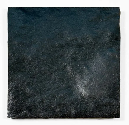 A single Metallic Black Onyx tile by New York Cement Tile with a glossy, slightly textured surface on a white background.
