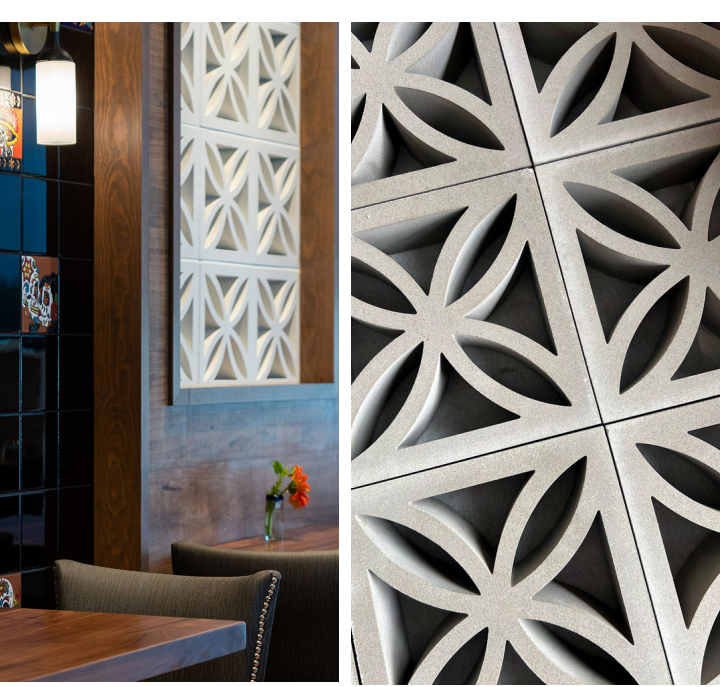 Close-up of decorative wall panels with geometric flower patterns in a modern, warmly lit restaurant interior.