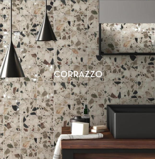 Modern kitchen with terrazzo tile backsplash, black pendant lights, and countertop decor; CORRAZZO text centered.