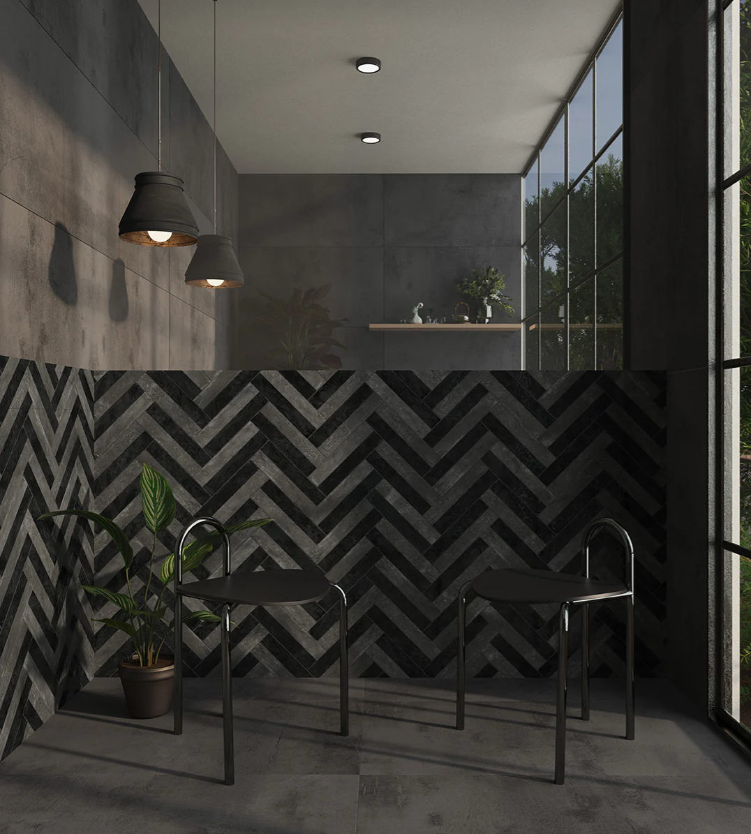 Modern room with dark chevron wall, two black chairs, potted plant, hanging lights, and large windows with outdoor view.