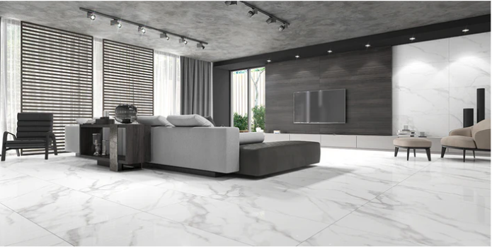 Modern living room with marble floors, gray sectional sofa, TV on wall, large windows, and minimalist decor.
