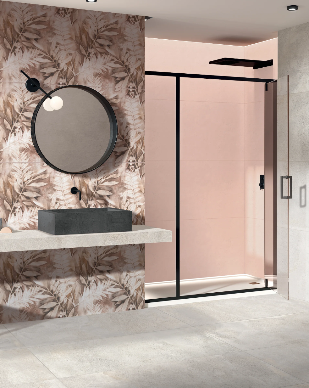 Modern bathroom with a round mirror, leaf-patterned wall, concrete sink, and a glass shower enclosure with black trim.