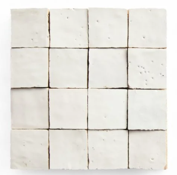 Frost 2X2 by New York Cement Tile: sixteen white handcrafted tiles with subtle imperfections and uneven edges.