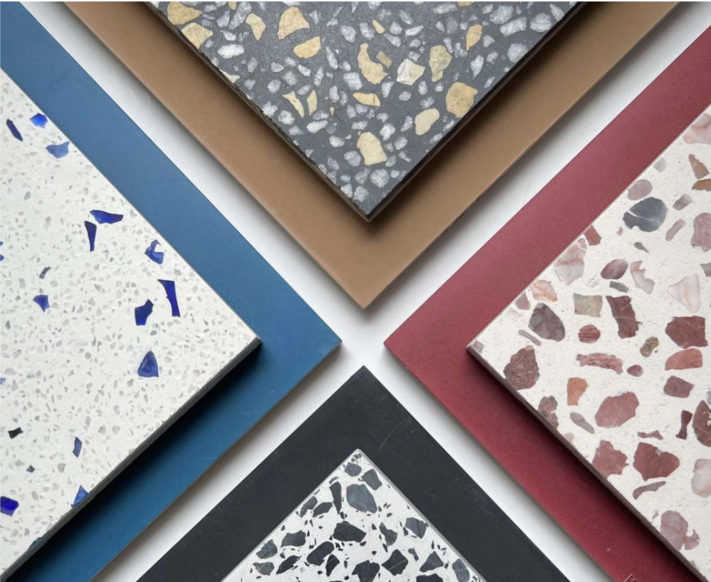 Six terrazzo tile samples with various colored chips on colored backgrounds arranged in a geometric, overlapping pattern.