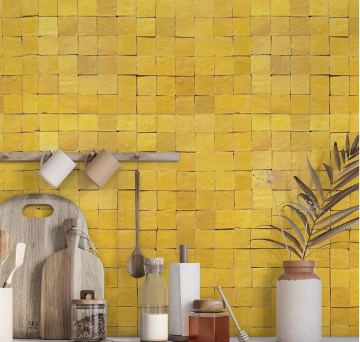 Kitchen with Sunflower Yellow 2X2 tiles by New York Cement Tile, cutting boards, utensils, jars, and a vase on the counter.