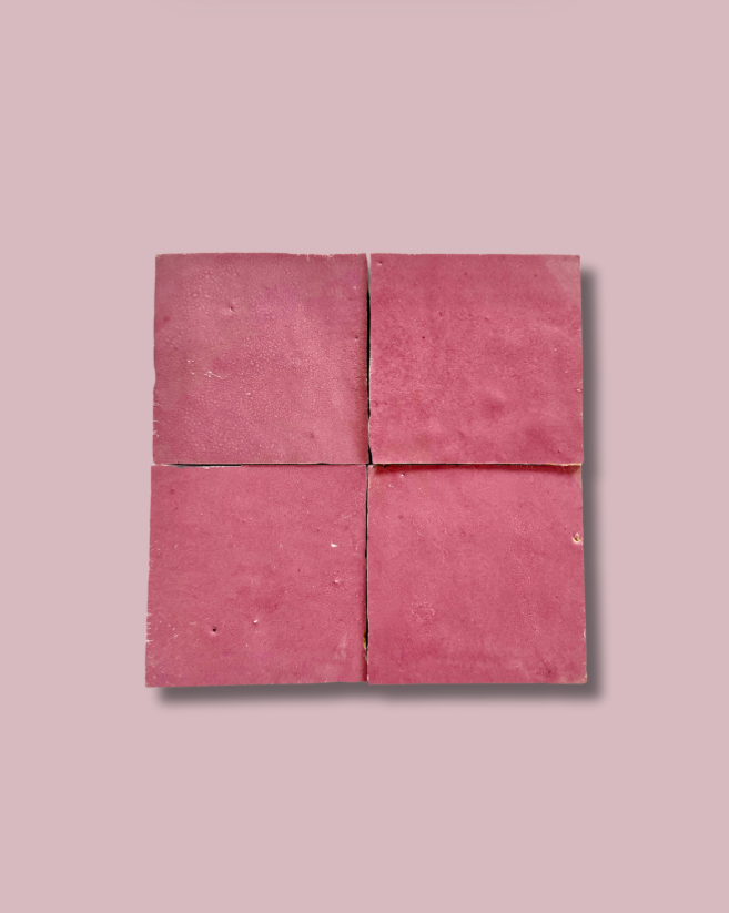 Four Vintage Rose tiles by New York Cement Tile arranged in a grid on light pink, casting soft shadows.
