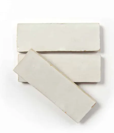 Three Pearl Grey (2x6) tiles by New York Cement Tile arranged in a staggered stack on a white background.