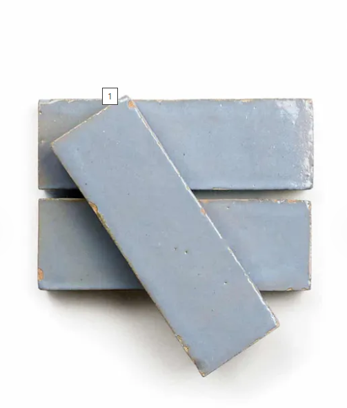 Two Arctic Blue (2X6) rectangular tiles by New York Cement Tile overlap in a cross on a white background.