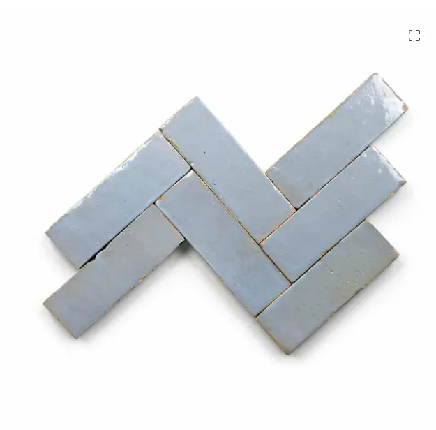 Six Arctic Blue (2x6) tiles by New York Cement Tile in a herringbone pattern on a white background.