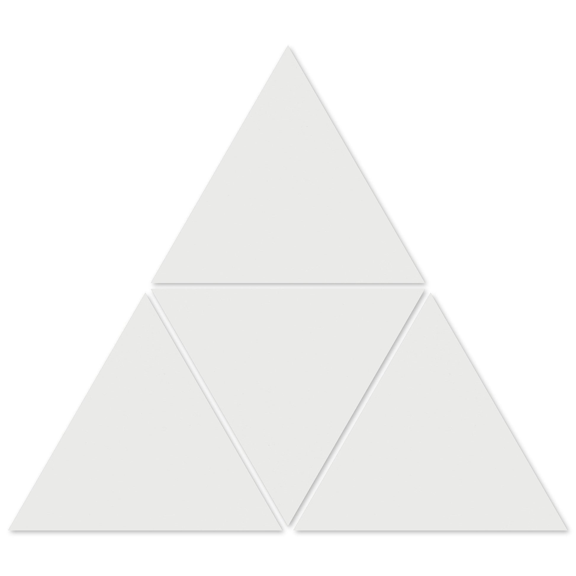 Four 1100-Solid White Triangle tiles from New York Cement Tile form a larger triangle with gaps—great for geometric designs.