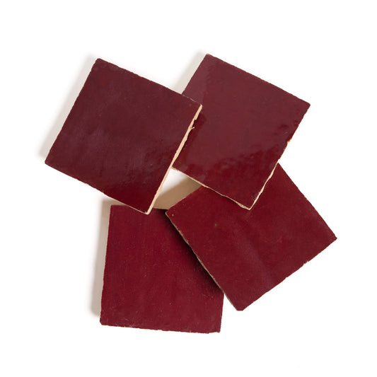 Four Glazed Sangria tiles by New York Cement Tile are slightly overlapping on a white background.
