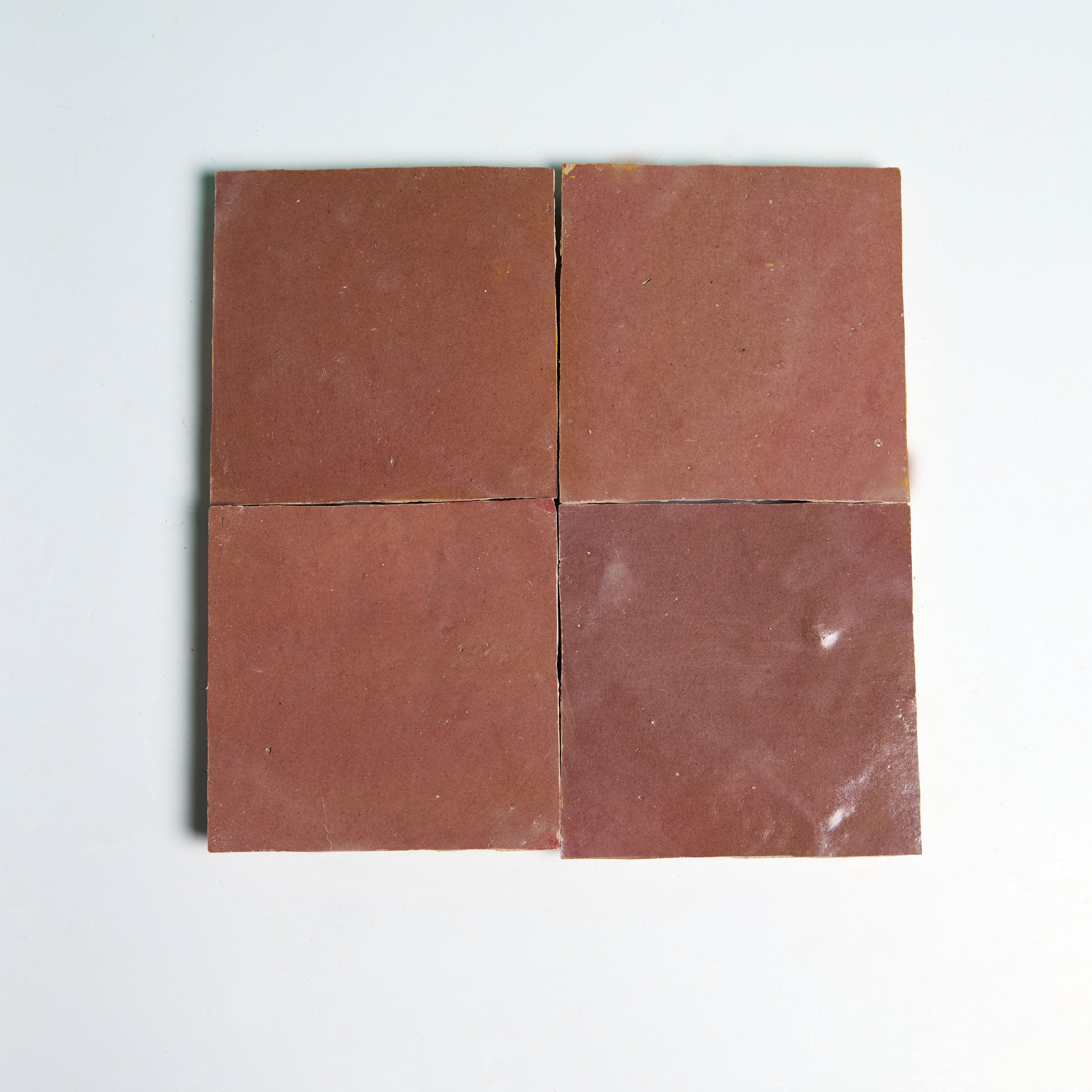 Four Glazed Copper Rose tiles by New York Cement Tile are arranged in a grid on a plain white background.