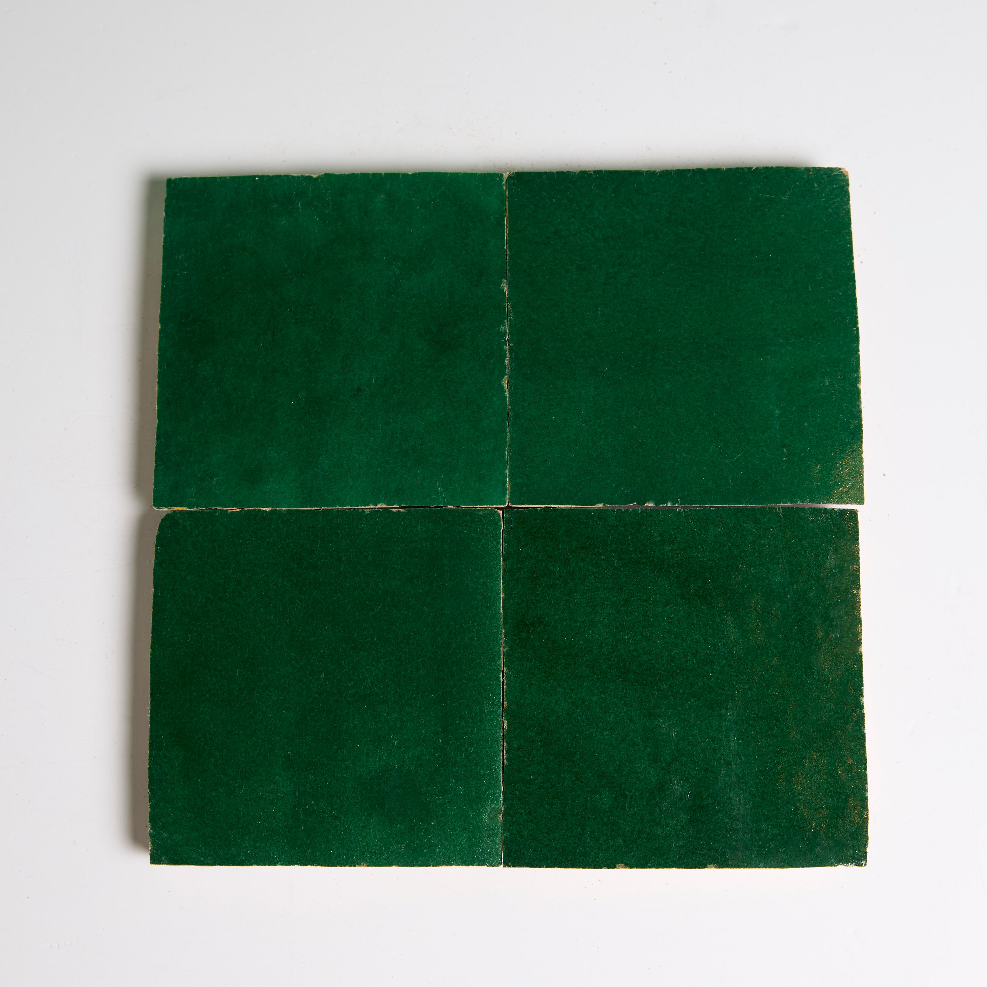 Four Jewel Green tiles by New York Cement Tile arranged in a grid on a white background.