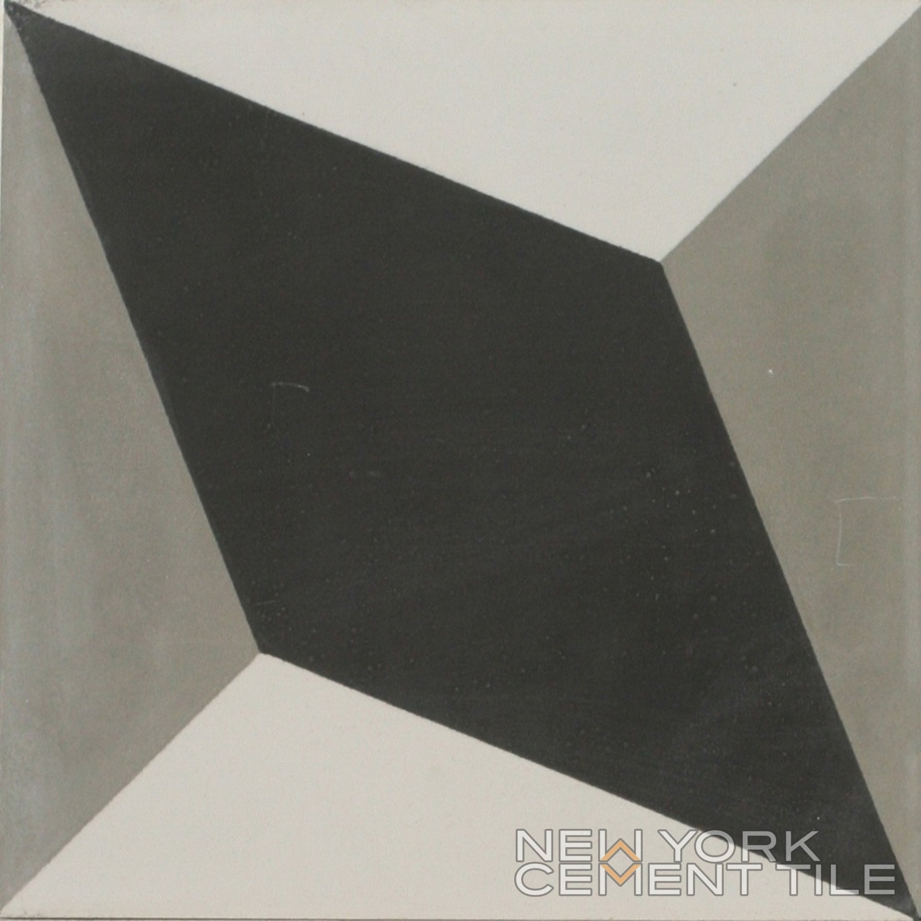 N20-034, a geometric cement tile by New York Cement Tile, features black diamonds and gray triangles; ideal for sustainable design.