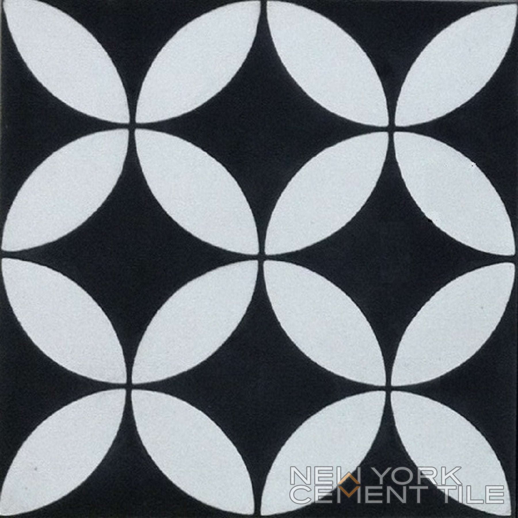 The N20-061 by New York Cement Tile is a black tile with white petal patterns—durable flooring for any space.