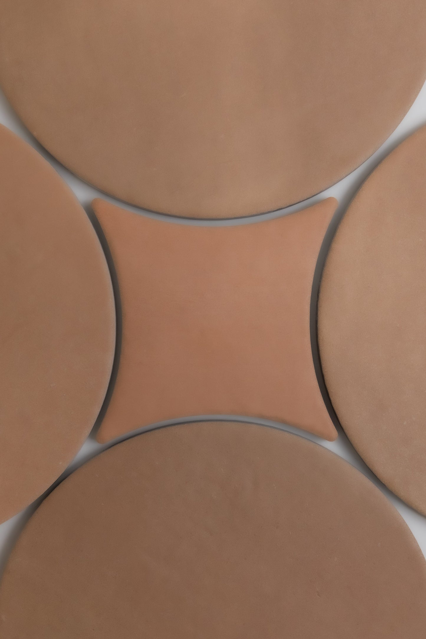 Arcilla by New York Cement Tile: one central concave square tile surrounded by four round tiles, viewed from above.