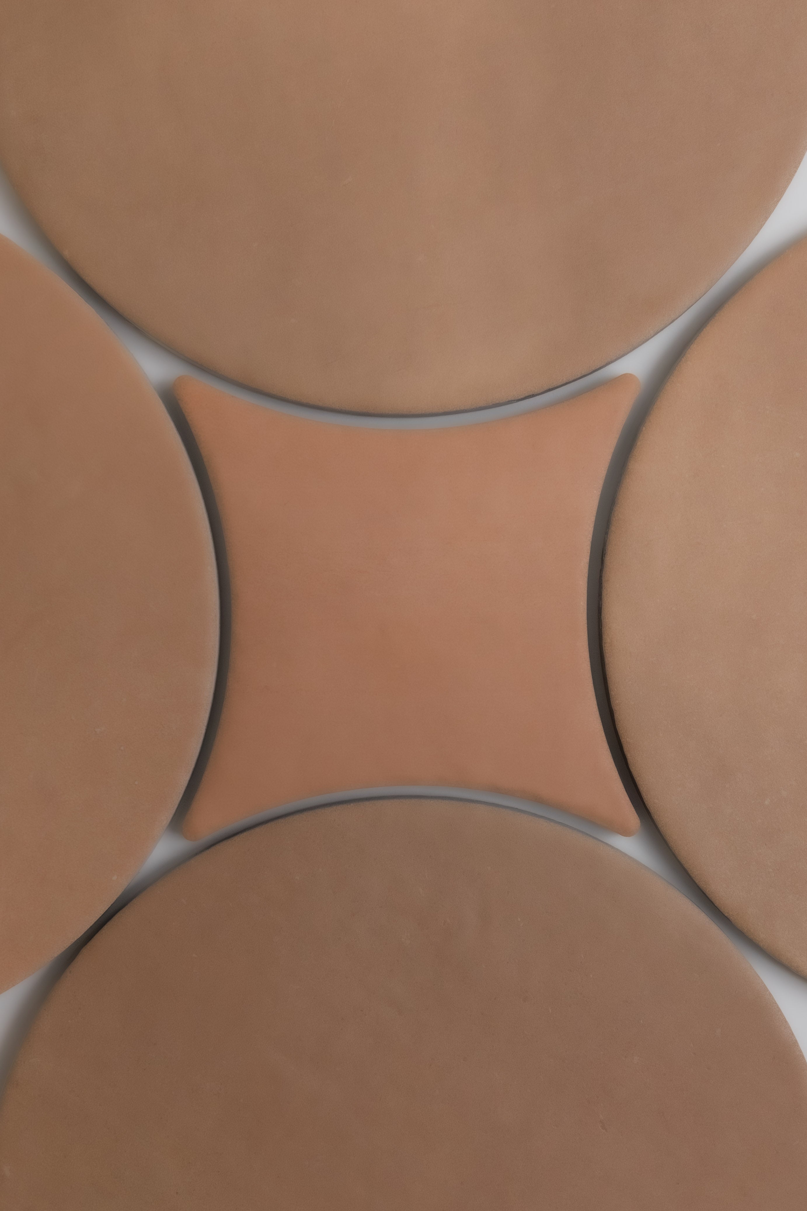 Arcilla by New York Cement Tile: one central concave square tile surrounded by four round tiles, viewed from above.