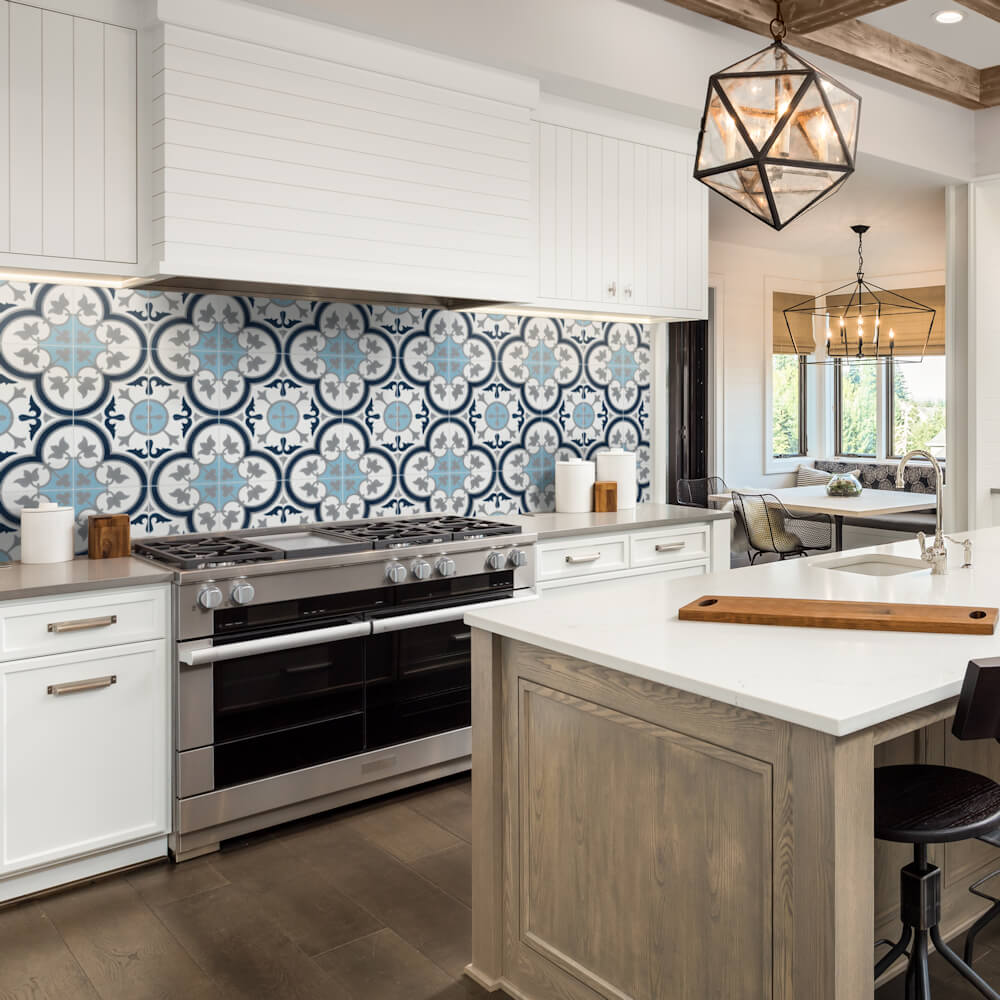 Modern kitchen with New York Cement Tile N20-045 Ice Blue backsplash, white cabinets, and a wooden-base center island.