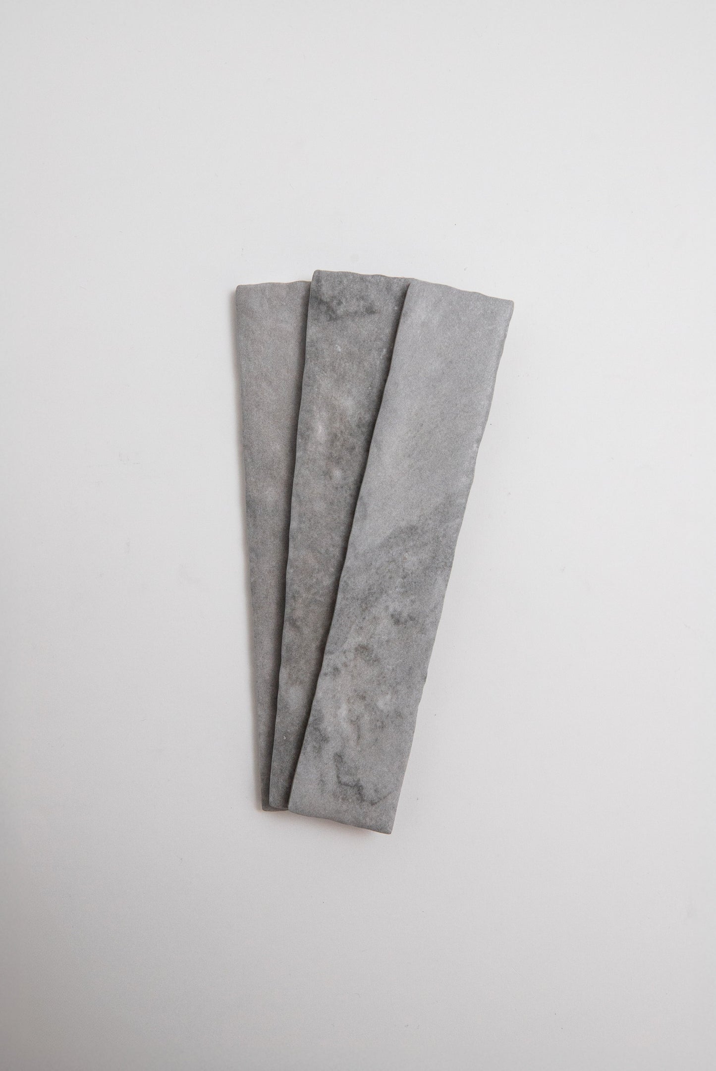 Three Tosca Bardiglio sample slabs arranged side by side on a plain white background.