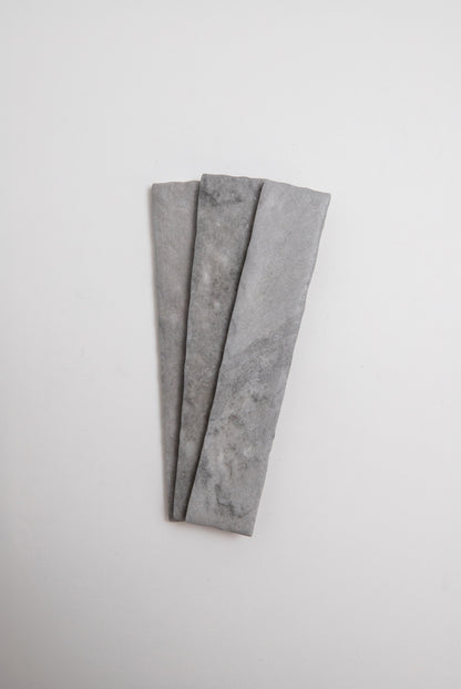 Three Tosca Bardiglio sample slabs arranged side by side on a plain white background.