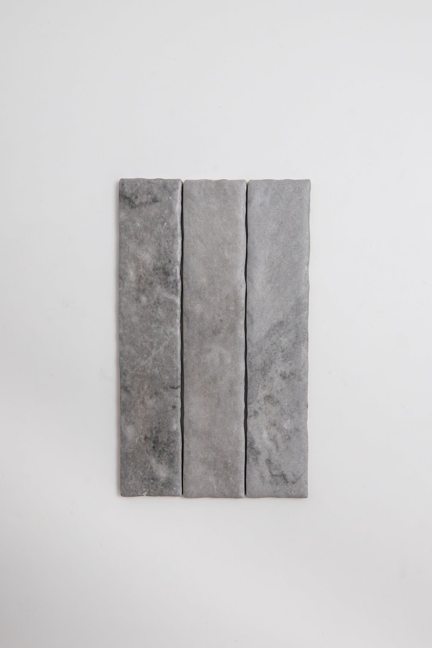 Three rectangular Tosca Bardiglio stone tile samples in gray, arranged vertically on a plain white background.