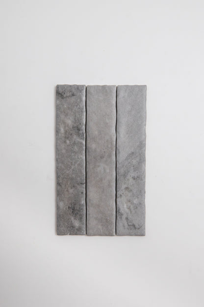 Three rectangular Tosca Bardiglio stone tile samples in gray, arranged vertically on a plain white background.