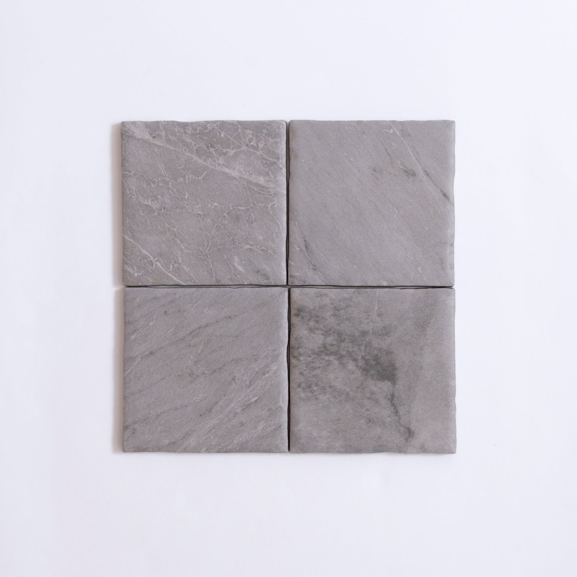 Four square Bardiglio tiles by Tosca arranged in a 2x2 grid on a white background.
